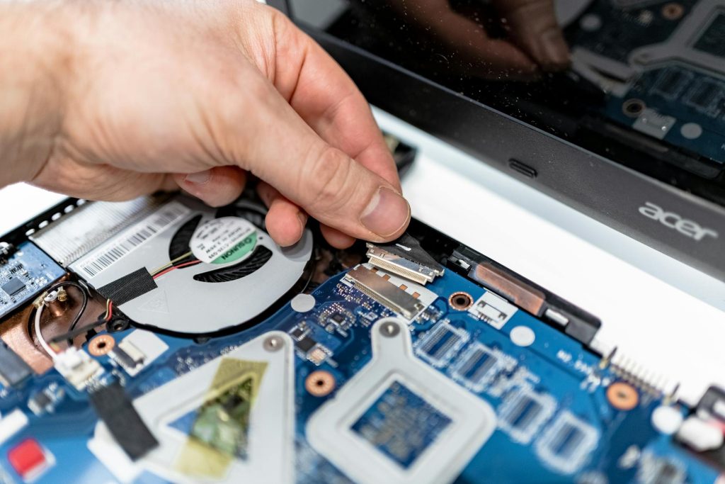 a person holding a connector tab on the circuit board