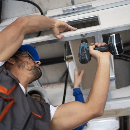 low-angle-people-working-with-drill